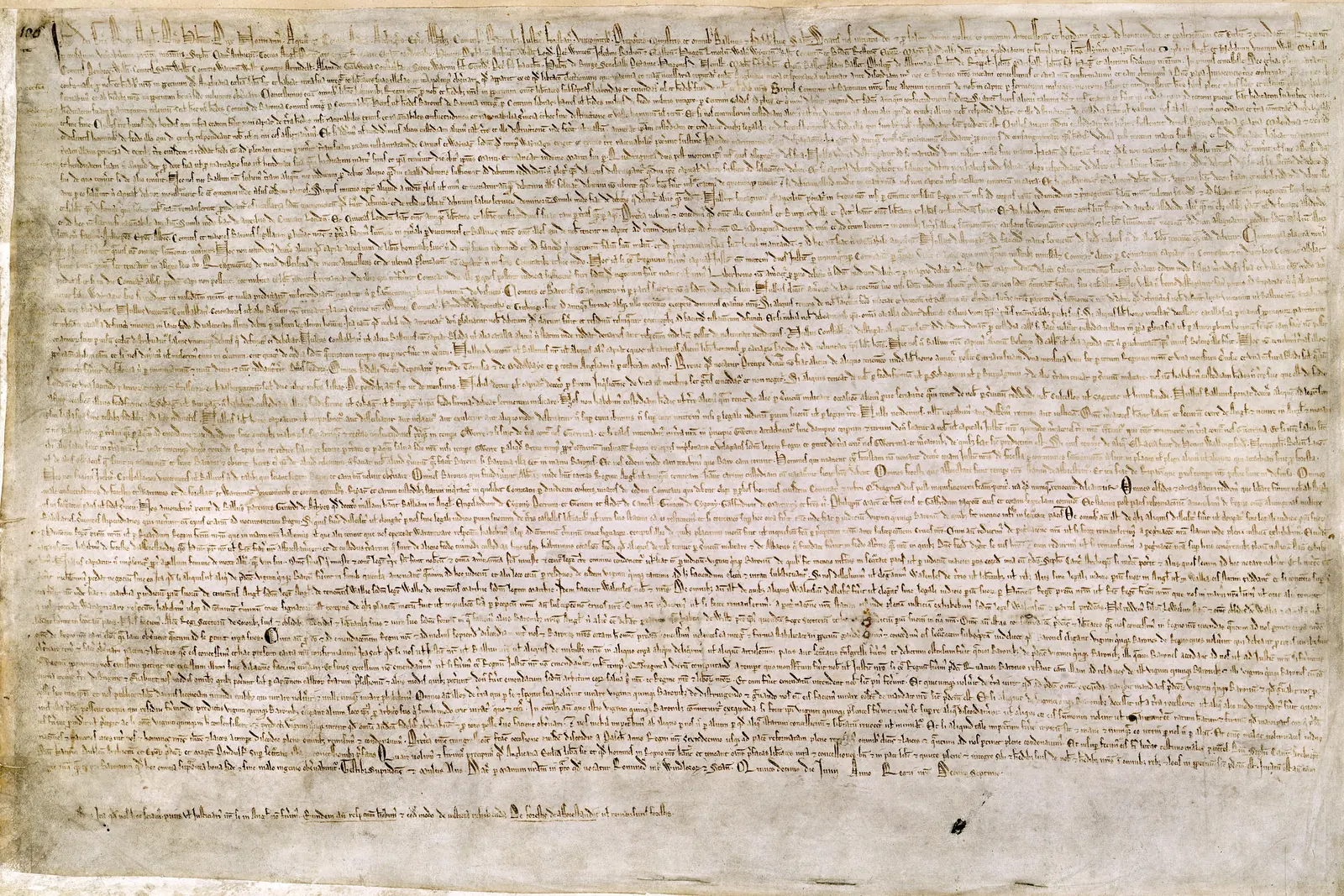 The 1215 Magna Carta in the British Library, dense Latin script on a pale parchment sheet.