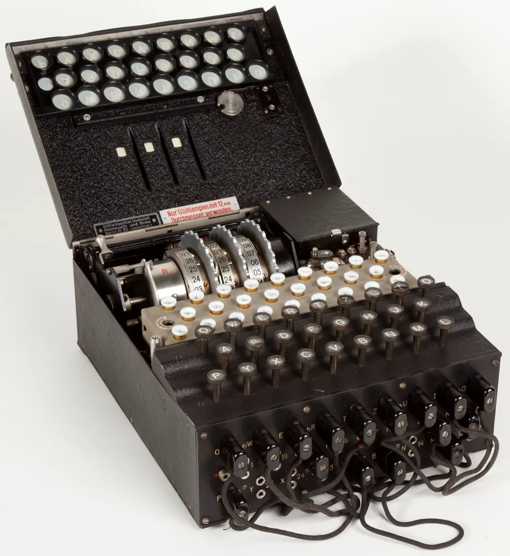 An Enigma cipher machine open at the science museum in Milan, lamps and rotors visible.