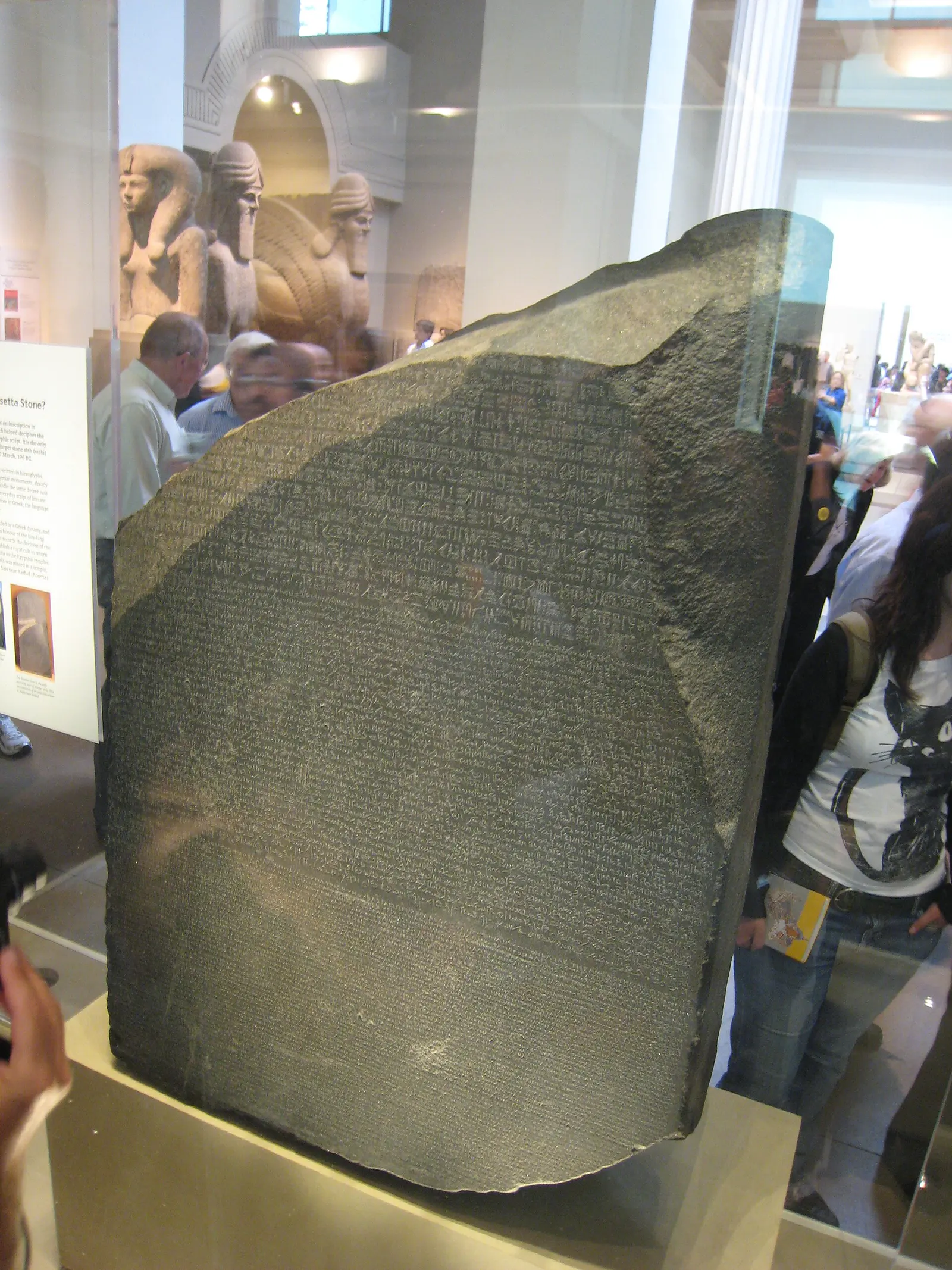 The Rosetta Stone, three scripts on one dark slab, photographed in the British Museum.