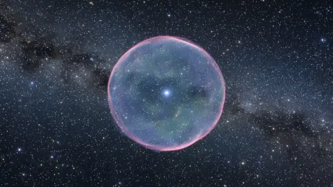 A faint round blue-violet nebula shell around a tiny white star, in a dense star field.