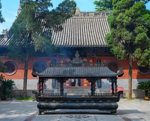 The White Horse Temple in Luoyang, red halls and a blue sky. Tradition links this temple to the first Buddhist texts in China.