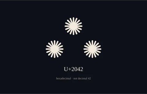 The asterism, three asterisks in a triangle, with U+2042 beneath. Hexadecimal, not decimal 42.