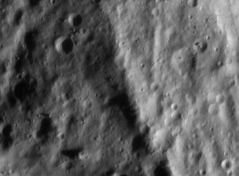 NEAR close-up of a long ridge on Eros just after local sunrise.